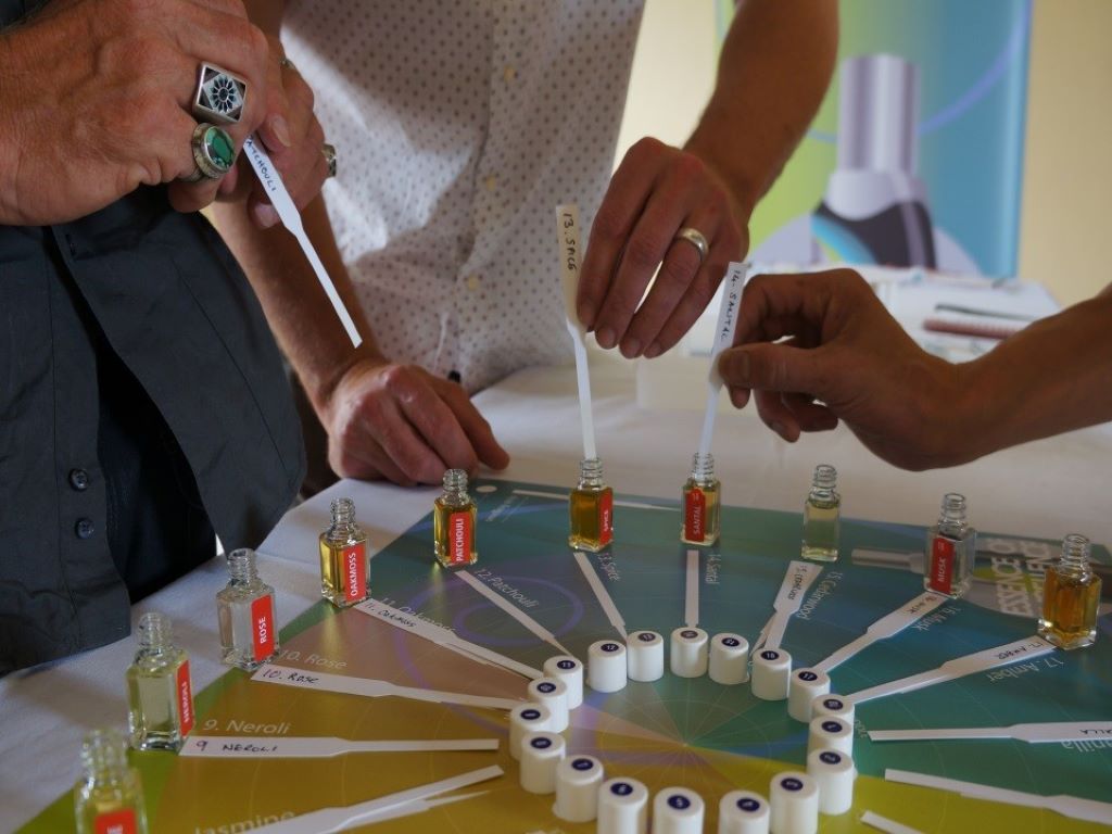 Team building participants trying different perfumes