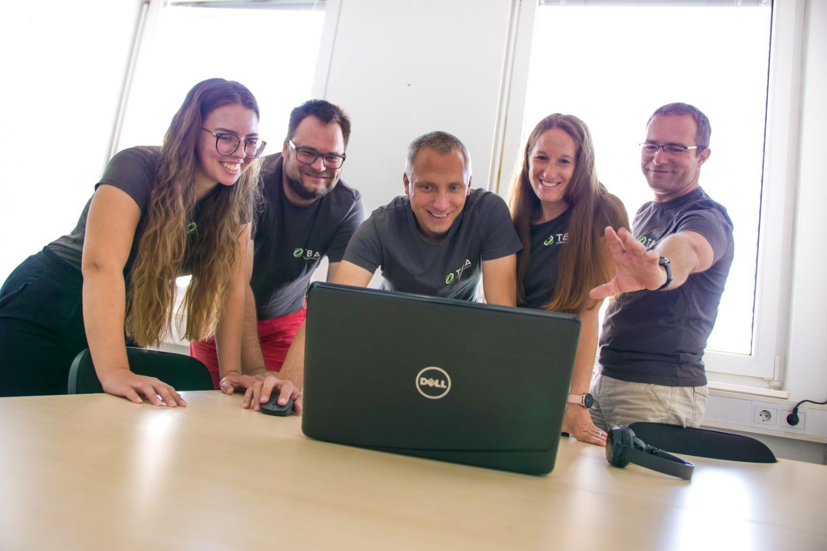 TBA team looking at a computer screen