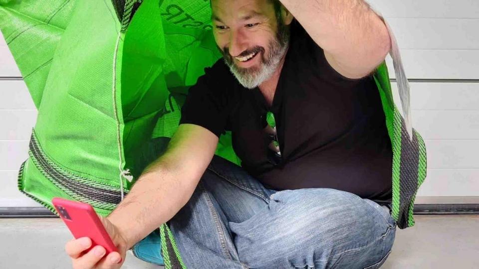 Participant taking a photo inside his "tent"/bag