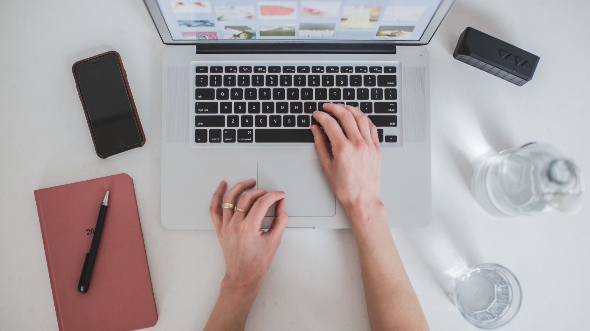 Woman typing on a laptop keyboard
